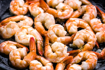 Fried prawn with garlic on pan, preparing dish with seafood, mediterranean cuisine concept
