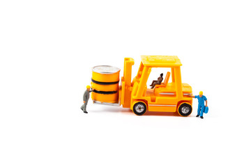 miniature worker and small forklift on white background