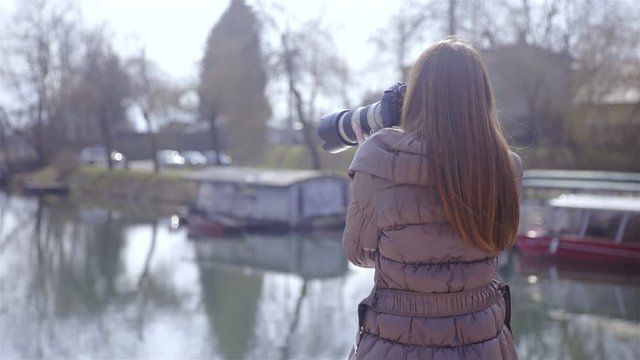 Nature photographer making photo of river 4K