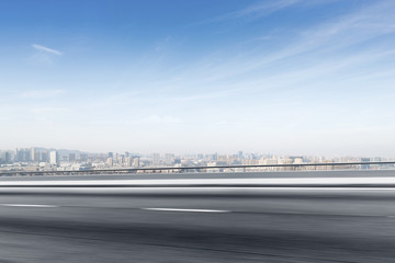 empty asphalt road with modern cityscape in foggy day