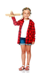 Little girl with a wooden plane in her hand.