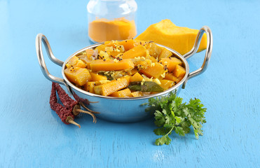 Sweet pumpkin curry, which is a healthy Indian vegetarian side dish for items like chapati, in a steel wok.