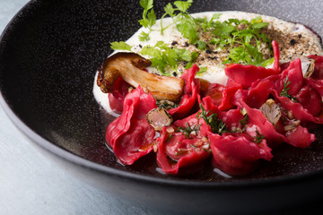 Red ravioli with mushrooms