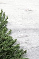 Christmas tree branches on wooden background 