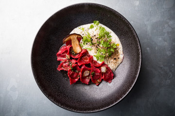 Red ravioli with mushrooms