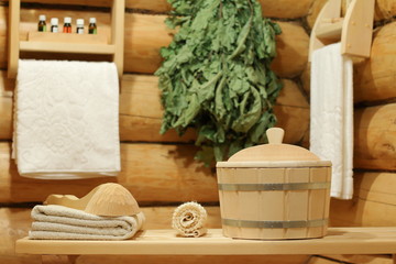 Fototapeta na wymiar Interior of sauna and bath accessories. Bath accessories in the log corner of the room of the Russian bath.