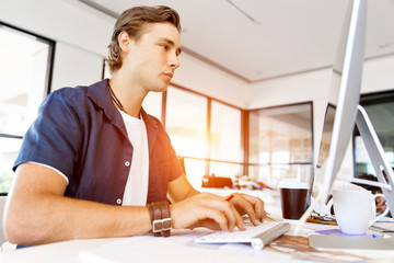 Handsome businessman working at computer