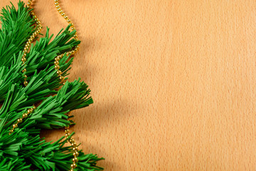 Handmade branches of a Christmas tree on a wooden background. Copyspace