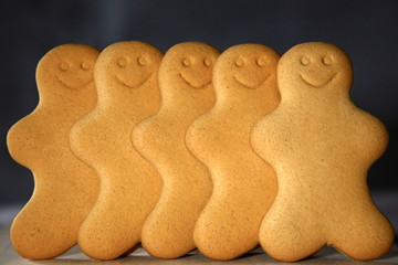 Row of smiling undecorated gingerbread men