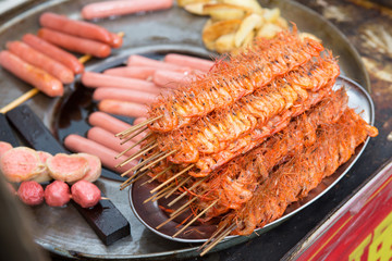 Fried grilled shrimp prawns on wooden skewers,chinese style
