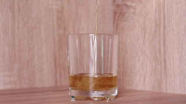 Pouring a glass with whiskey