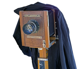 Wooden classic retro camera on tripod on white