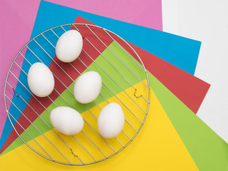 Easter Eggs on colorful background. The concept of a holiday and a happy Easter. Top view. Copy space. Easter mock up.