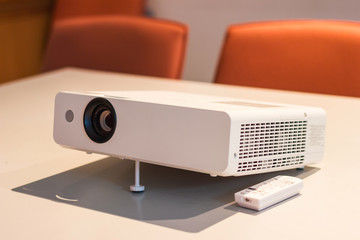projector for presentation in a meeting room with notebook background, (Light in a light yellow tone room.)