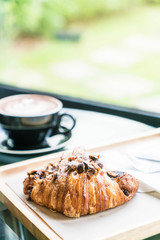 hazelnut croissant with hot coffee