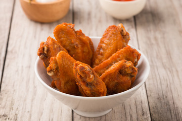 plate of chicken wings on wood