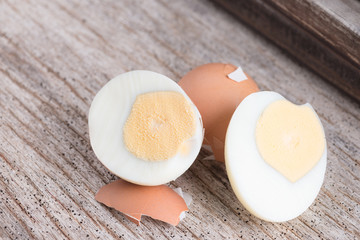 Peeled boiled egg on wood background