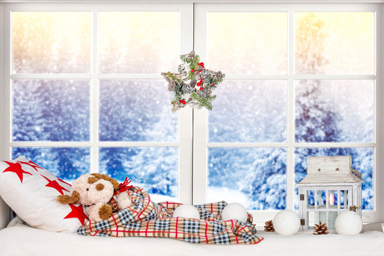 Merry Christmas And Happy Holidays! Christmas Decor In The Window,toy Dog Sleeps On A Pillow Under A Blanket.