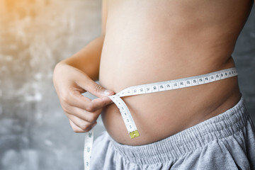 Portrait Asian fat boy concept healthy and lose weight ,selective and soft focus