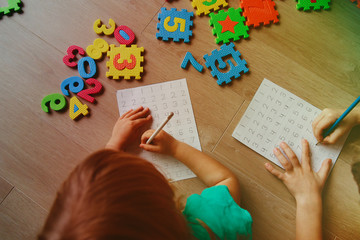 little boy and girl learn to write and calculate numbers