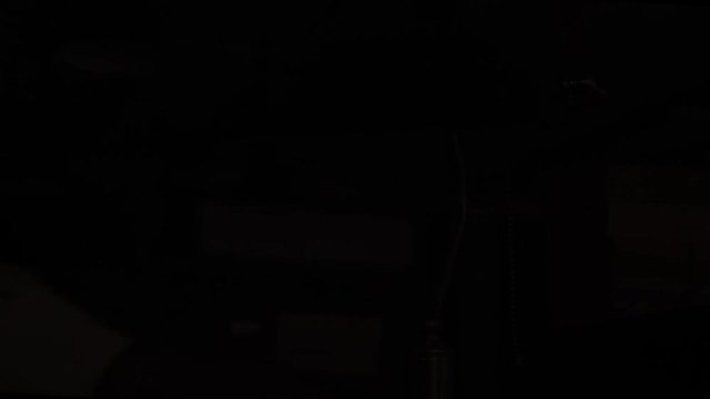 Female Hand Turned Off Green Table Lamp in Library. 4K.