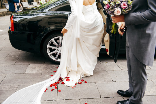 Bride getting into car