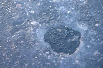 Ice hole ready hor ice fishing on frozen lake, sunrise light