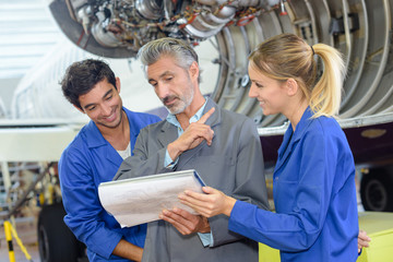 aviation students looking at folder with teacher