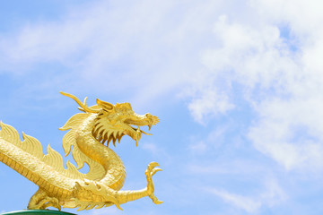 dragon statue  sky blue is the backdrop.