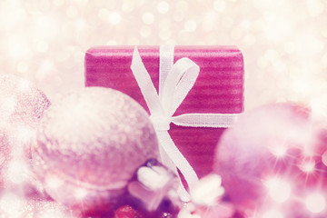 Close up of red gift box and Christmas decoration over abstract background