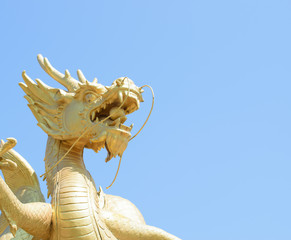 Chinese dragon statue in the mouth with glass balls On the blue sky background