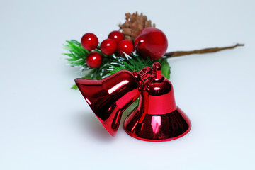 Red Christmas decorative bells with a yellow ribbon on a white background
