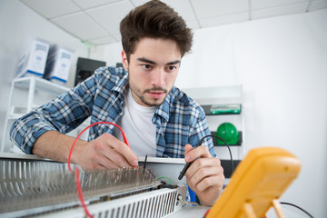 young man intently working with electronic parts