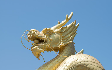 Chinese dragon statue in the mouth with glass balls On the blue sky background