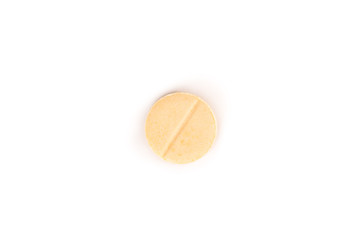 close-up of a light yellow pill from above isolated on a white background.psd