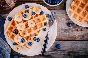 Fresh homemade belgian waffles with blueberries and banana for breakfast