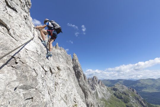 Climber on the via ferrata Roghel, Popera group, Sexten Dolomites, Comelico Superiore, Belluno, Veneto, Italy