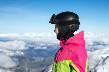 Fototapeta na wymiar Young, sexy woman is skiing in winter paradise in the alps with a beautiful blue sky and wonderful white snowy mountains 