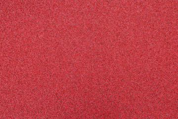 Red artificial tennis court background.