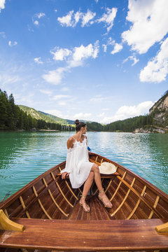 Woman traveling by boat in Pragser Wildsee lake