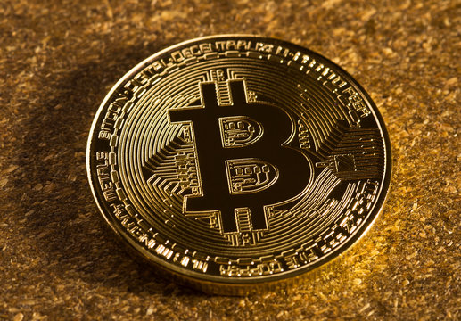 Gold bitcoin on the surface of wood