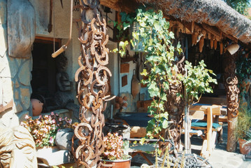 Farm village background, a hungarian vintage retro house decorated with plants, ivy and old rusty metal horseshoes.