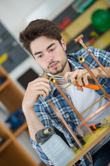 plumber working with copper central heating pipes