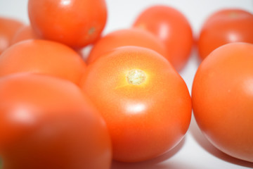 Bright Red Tomatoes with white background nothing else