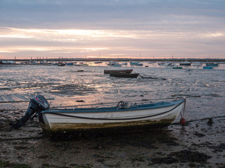 sun set sky dramatic clouds sea front beach harbor marina boats moored landscape