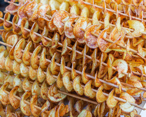 Street food. Spiral potato chips on a sticks