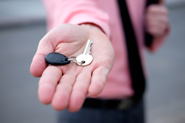 Fototapeta premium man realtor offering keys from new house hand closeup