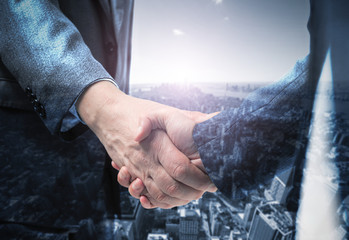 Business handshake, blue toned image