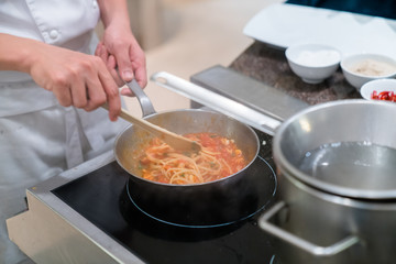 chef cooking spaghetti