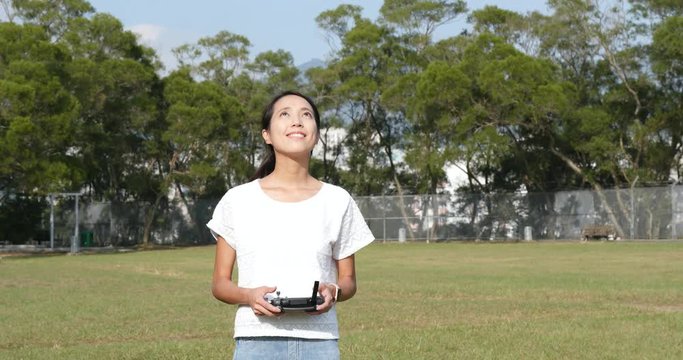 Woman control fly drone with at outdoor